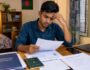 Bangladeshi job seeker reviewing documents before applying for Saudi Arabia job